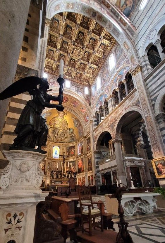 Interior of Pisa Cathedral showing the Romanesque nave and marble decoration.